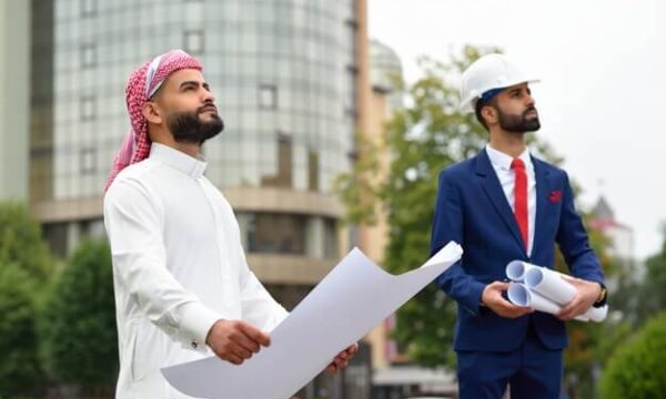 proud-saudi-businessman-looking-his-developing-city-holding-blueprint_7502-5292